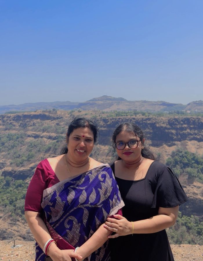 Payel and a family member on a hilltop